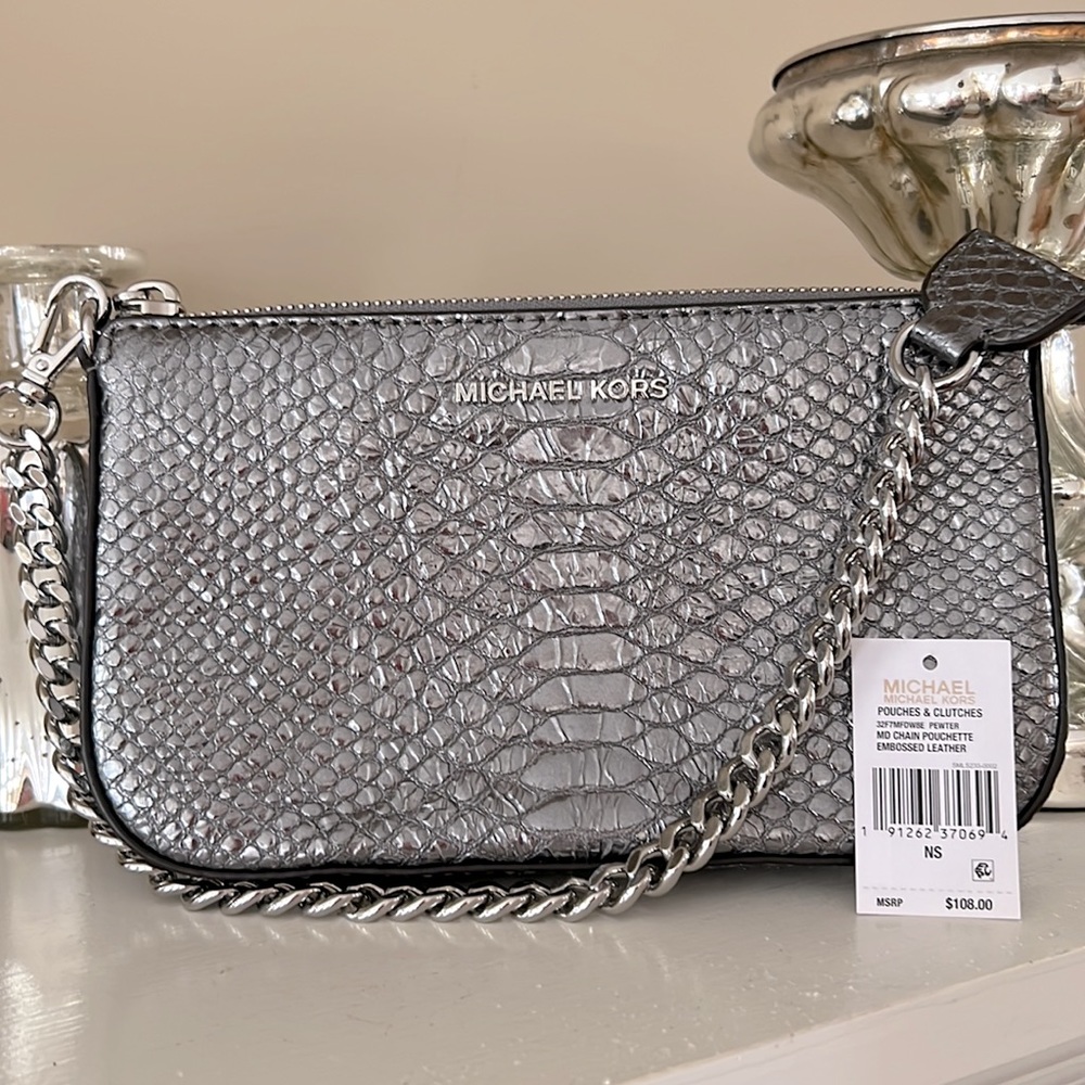 Michael Kors silver textured bag. Great to use as bag or accessory.
